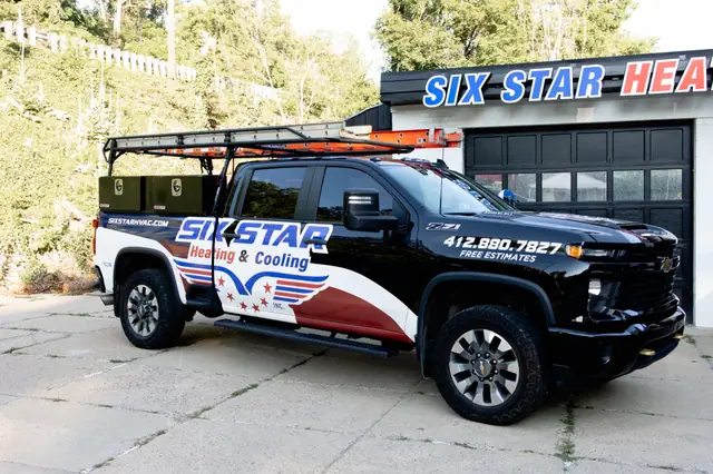 Six Star Heating & Cooling branded service truck parked at the Carnegie shop.